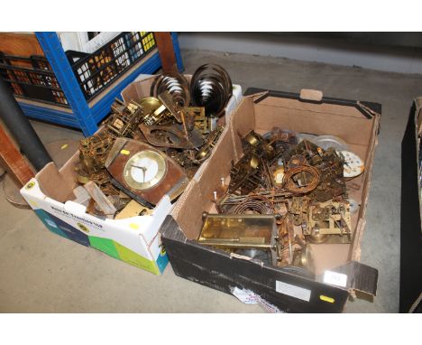 Two boxes containing various clock parts, mantel clocks etc.