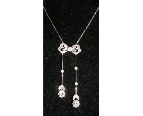 A diamond "Bow and Drop" pendant and chain with two brilliant cut diamonds