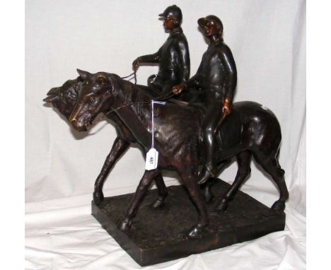 A bronze group of two huntsmen, one with hunting horn, on rectangular base - 52cm high overall