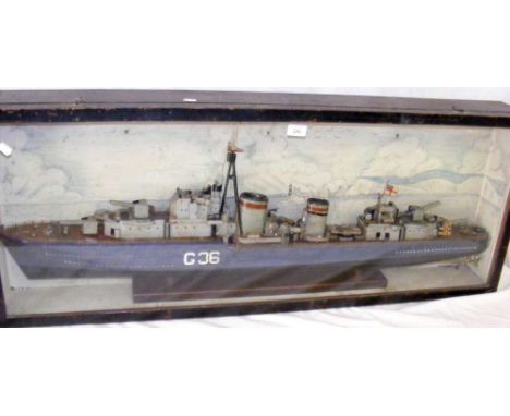 An old wooden model of the gunship "G-36" in glazed case depicting The Needles to the background - 46cm x 117cm overall