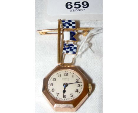 A lady's brooch/watch in 9ct gold octagonal case by Benzie of Cowes with three enamel signalling flags attached