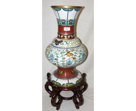 A Chinese cloisonne vase with butterfly and scroll design and ornate shaped hardwood base - 72cm high overall