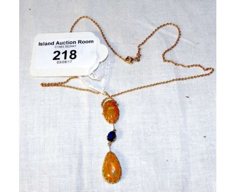 An 18ct gold fire opal and sapphire pendant and chain