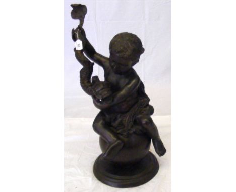 A bronze figure of a cherub seated on a globe and holding a stylized dolphin - 79cm high overall