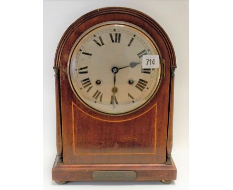 1920's mahogany inlaid three-train mantel clock, the arched case with 6 inch silvered dial with Roman numerals, the movement 