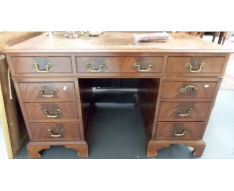 Reproduction mahogany veneered twin pedestal desk, the brown gilt tooled leather inset over an arrangement of nine drawers &a