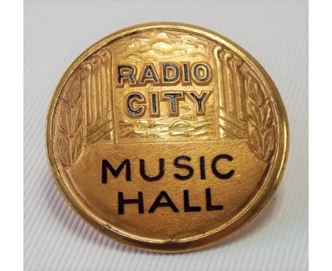 Rare early 20th Century American Art Deco gilt metal &amp; enamel mount or badge for 'RADIO CITY MUSIC HALL', diameter 39mm a