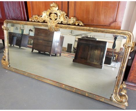 Victorian large gilt framed rectangular over mantel mirror, the gilt wooden gesso frame with foliate scroll surmount, the sid