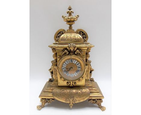 19th Century French Ormolu two train mantle clock, the architectural case with foliate scrolls and surmounted by a twin handl