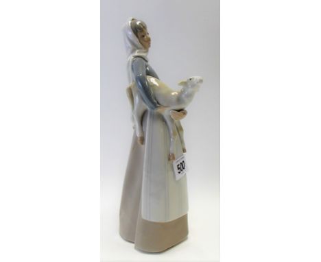 Lladro porcelain model of a shepherdess with lamb  in her arms, height 28cm.