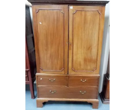 19th Century mahogany linen press, the moulded dentil cornice over two cupboard doors enclosing four slides, the base with tw