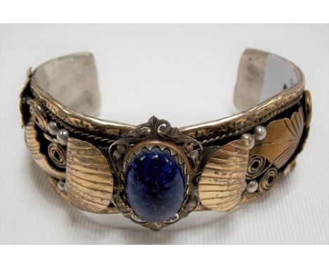 20th Century Native American stirling silver bangle with oval blue stone cabochon inset signed A. Edsitty, weight 49.7g appro