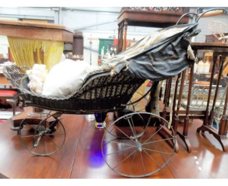 Victorian wicker button back upholstered three wheeled child's push chair, length 100cm.