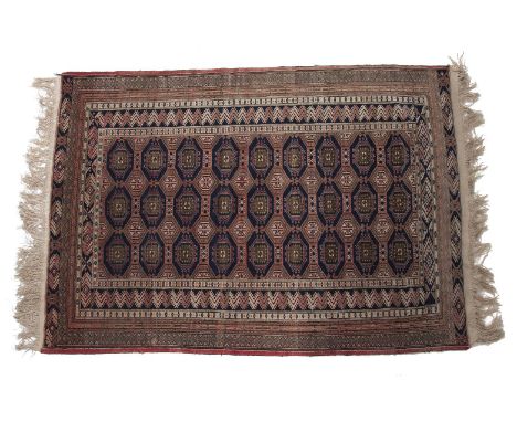 A BOKHARA WOOL RUG, the central field with multiple octagonal medallions on navy blue ground, within borders and guard stripe
