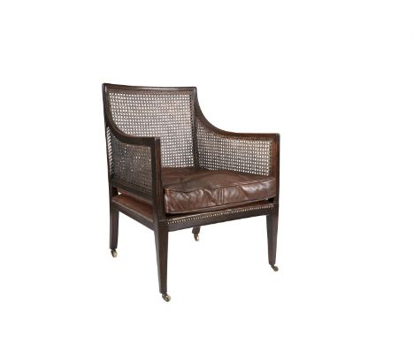 A 19TH CENTURY MAHOGANY AND CANE WORK BERGÈRE, with rectangular back and sides, with button upholstered leather seat cushion,