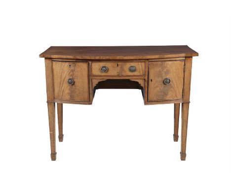 A LATE 19TH CENTURY MAHOGANY COMPACT SIDEBOARD, of bowed rectangular form, the plain top above single frieze drawer to the le