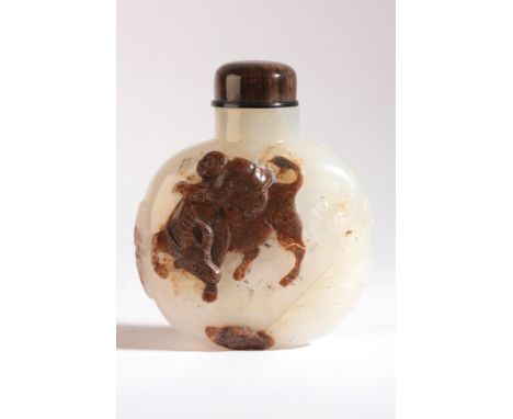 A CHINESE JADE SNUFF BOTTLE 19th century, the white and russet stone carved with an ox and rider to one side and a kneeling f