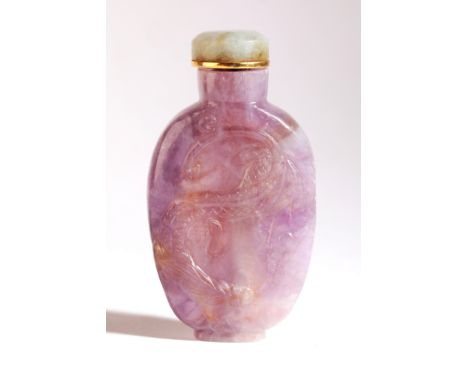 A CHINESE AMETHYST SNUFF BOTTLE 19th century, with a carved dragon to the front and phoenix to the reverse, 6.5cm high overal