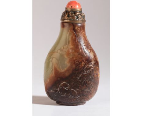 A CHINESE JADE SNUFF BOTTLE 18th century, the yellow-green nephrite carved with goats in a rocky landscape, with an open work