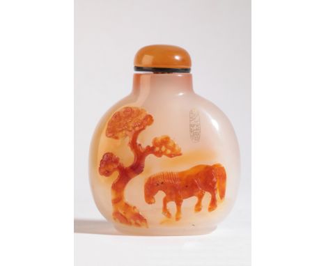 A CHINESE AGATE SNUFF BOTTLE 19th century, of circular form with a horse under a pine tree carved to the front, a small seal 
