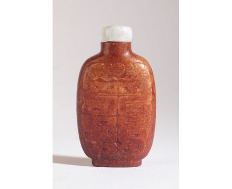 A CHINESE BROWN JADE SNUFF BOTTLE 18th/19th century, of flattened form with archaic characters and dragons, 7cm high overallT