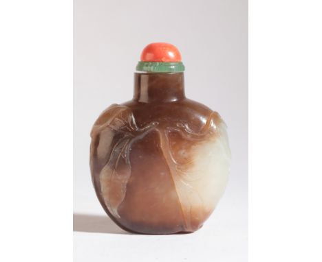 A CHINESE JADE SNUFF BOTTLE 19th century, the bulbous body carved with leaves and hanging fruit, 6cm high overallThe Dick Har