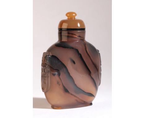 A CHINESE AGATE SNUFF BOTTLE 18th/19th century, with carved mask and ring handles to each side, 8cm high overallThe Dick Hard