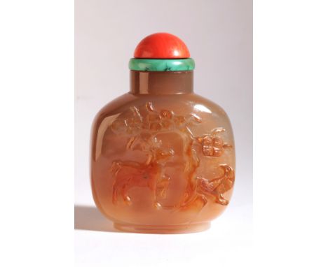 A CHINESE AGATE SNUFF BOTTLE early 19th century, carved to the front with a stag and a bird underneath a pine tree, the rever