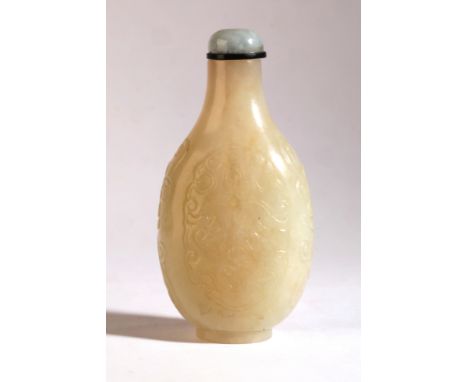 A CHINESE PALE GREEN JADE SNUFF BOTTLE Qing Dynasty, carved and incised with lotuses and 'shou' symbols, 9cm high overallProv