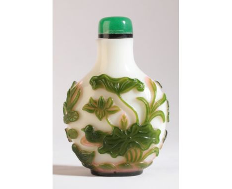 A CHINESE GREEN AND PINK OVERLAY GLASS SNUFF BOTTLE 19th century, the overlay depicting a pond scene of ducks and lily pads, 