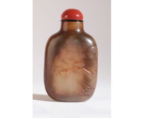 A CHINESE JADE SNUFF BOTTLE probably early 18th century, the yellow-green nephrite body carved with a chilong, 7cm high overa