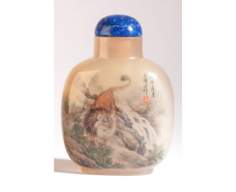 A CHINESE AGATE INSIDE PAINTED SNUFF BOTTLE SIGNED BY WANG XISAN dated 1978, the front decorated with a lion prowling beside 