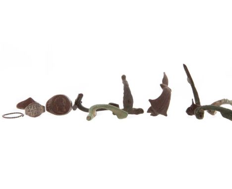 TWELVE FIBULAE,likely Roman and Celtic, of varied sizes, along with five Roman-type rings and a cross (18)