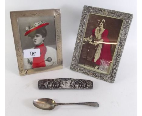 Two silver photograph frames, one with embossed decoration 16 x 11cm, a white metal comb frame and a silver spoon