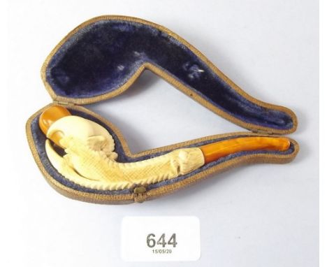 A 19th century carved ivory and amber mounted pipe in the form of a claw, cased