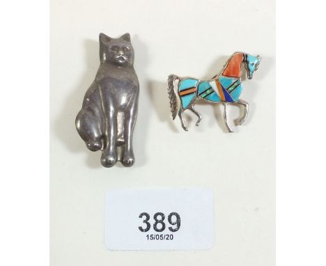 A silver cat brooch and silver stone set horse brooch