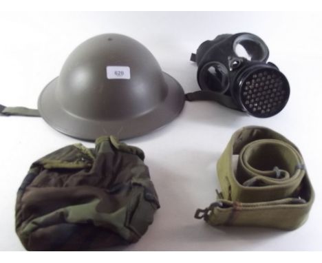 A WWII tin helmet, a gas mask 1942 and a belt