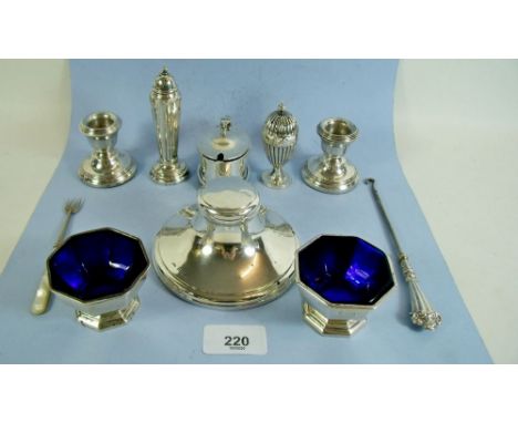 A collection of small silver items to include capstan inkwell, salts, a pair of squat candlesticks, pepperette etc.