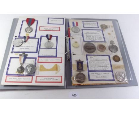 A folder of Royal Family commemorative medals and medallions - all mounted and taped on card. Includes King George VI Imperia