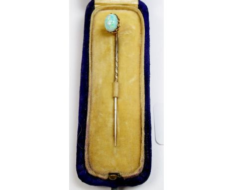 A gold and opal set stick pin, cased, unmarked but tested gold