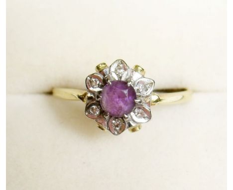 An 18 carat gold diamond and amethyst cluster ring, size S