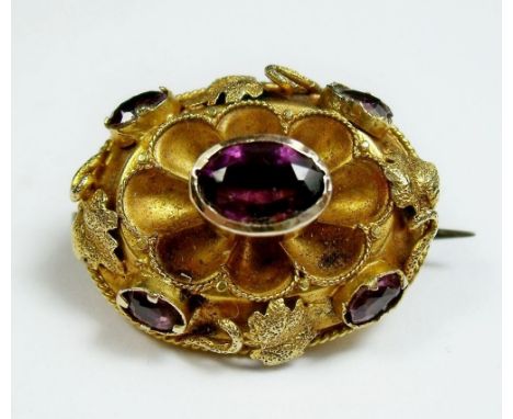 A Victorian 15ct gold (tested) and amethyst brooch - 2.5 grams, 2cm wide