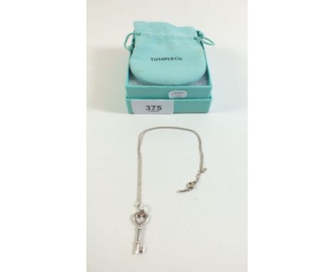 A Tiffany and Co silver key pendant and chain - boxed