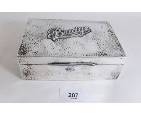 A silver box for Bridge playing cards with hammered decoration and 'Bridge' to lid, black leather lined interior, 15cm wide, 