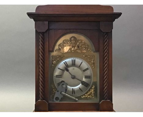 LATE VICTORIAN MANTEL CLOCK THE ARCHED BRASS AND SILVERISED DIAL WITH EIGHT DAY MOVEMENT contained in a walnut case,37cm high