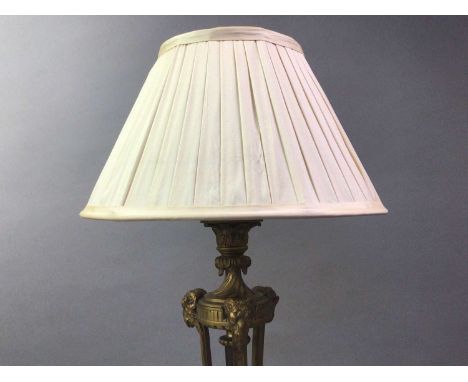 FRENCH EMPIRE TABLE LAMP EARLY 20TH CENTURY decorated with three rams heads and turned scrolls, on marble base58.5cm highQty:
