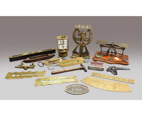 A set of brass scissor action letter scales, another set of postal scales, a clockwork desk top perpetual calendar, a pair of