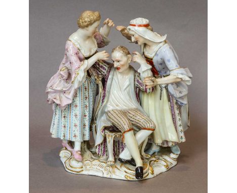 A Meissen figure group, late 19th century, modelled as a lady and housekeeper flanking a seated gentleman and raised on a roc
