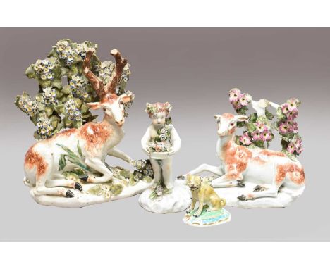 A pair of Derby models of a recumbent stag and doe, circa 1780, each lying before a bocage on a simple pad base, patch marks,