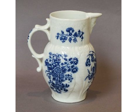A Caughley leaf-moulded mask jug, circa 1775, printed in underglaze blue with the Three Flowers pattern, printed S mark, 15cm